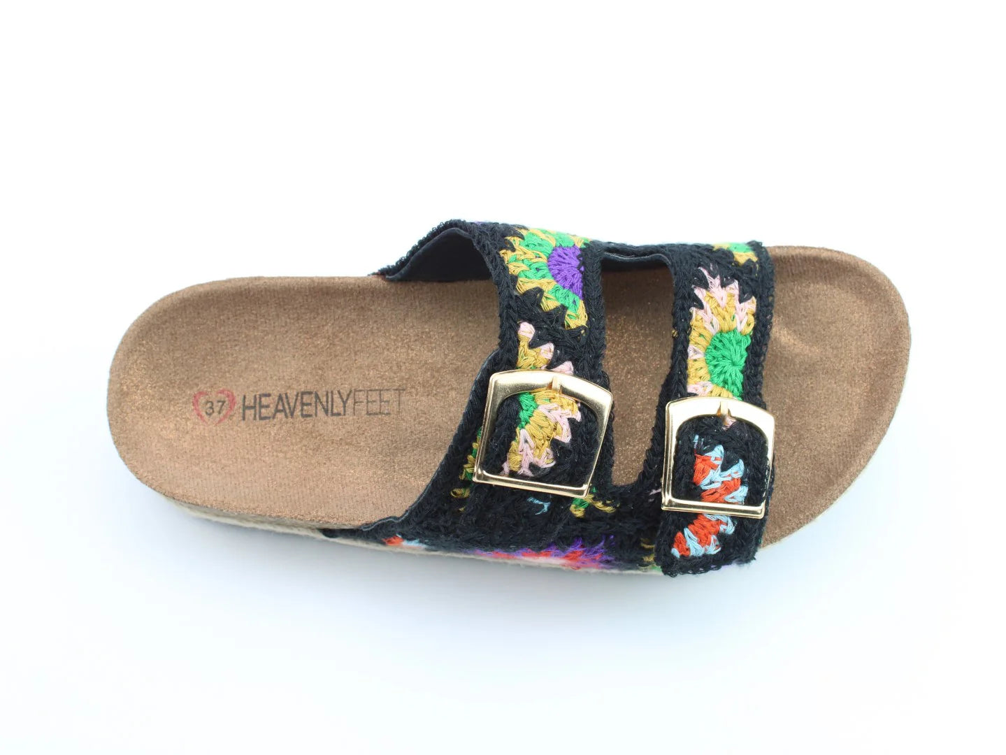 A single vegan-friendly sandal with a cork sole, two gold buckles, and a colourful stitched upper on a black strap, labelled Heavenly Feet inside.