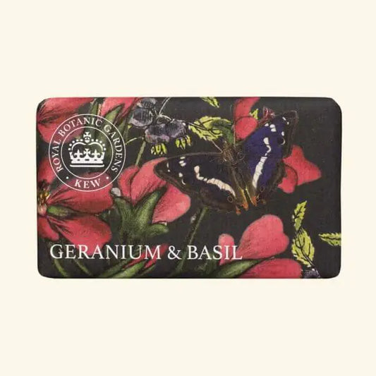 A rectangular Kew Gardens Geranium and Basil Soap bar adorned with floral and butterfly motifs, labelled Royal Botanic Gardens, Kew. This vegan-friendly soap adds an elegant, botanical touch to your bathing routine.