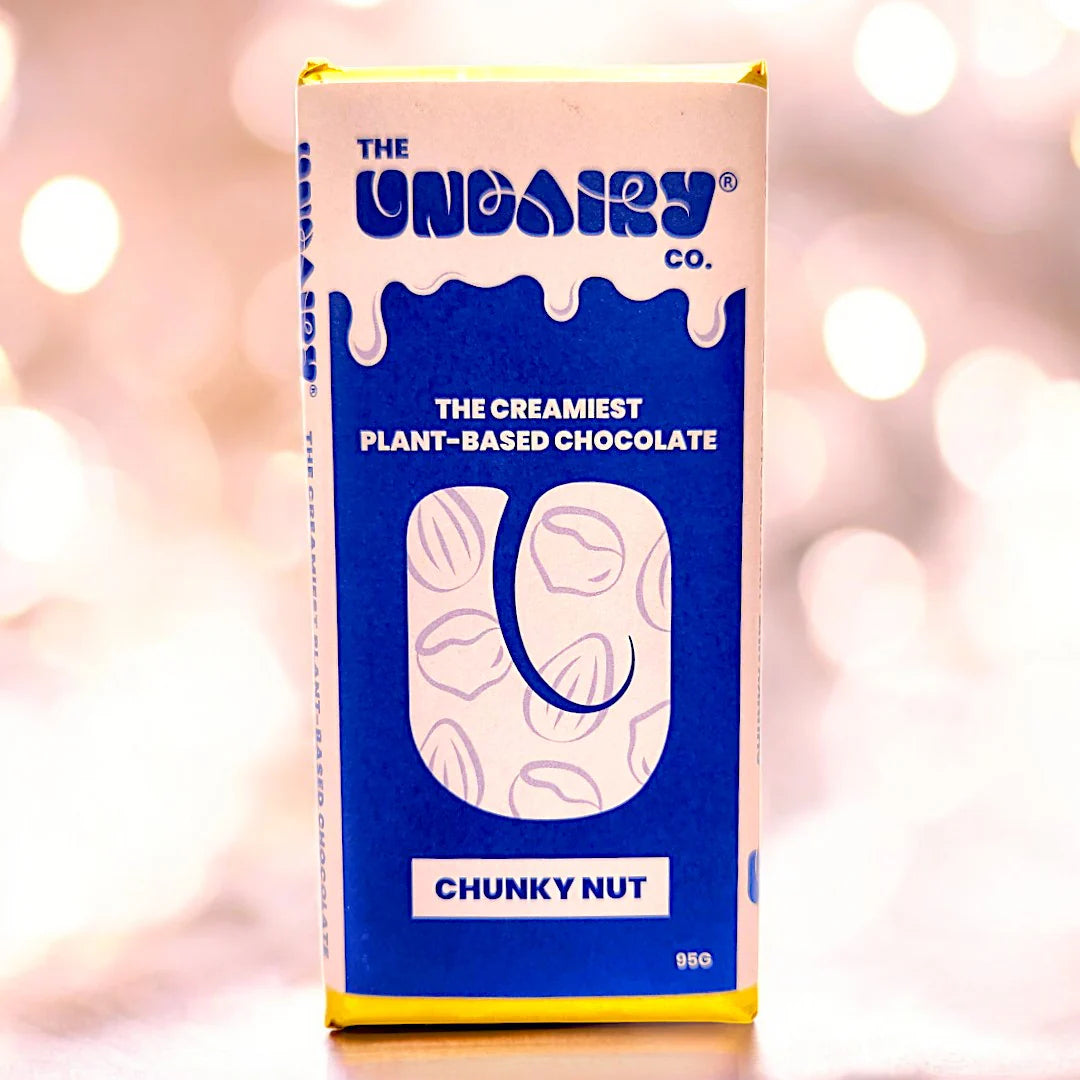 A blue and white box labelled The UnDairy Co. Chunky Nut, featuring the text The Creamiest Plant-Based Chocolate and illustrations of nuts, offering a vegan take on classic dairy-free chocolate.