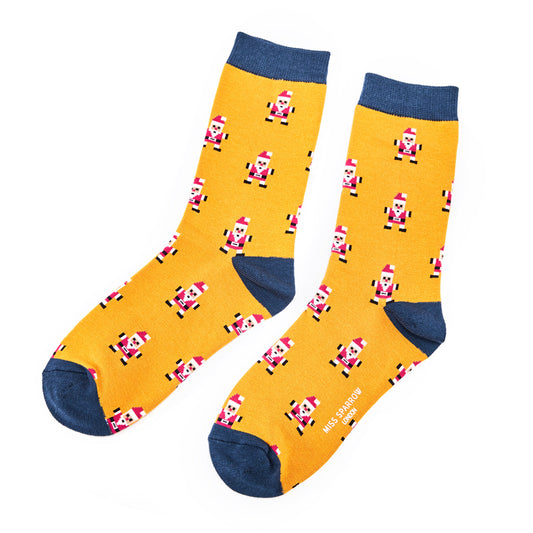 A pair of yellow socks with blue cuffs, heels, and toes, displaying a repeating pixelated dancing Santa motif—an ideal Christmas present.