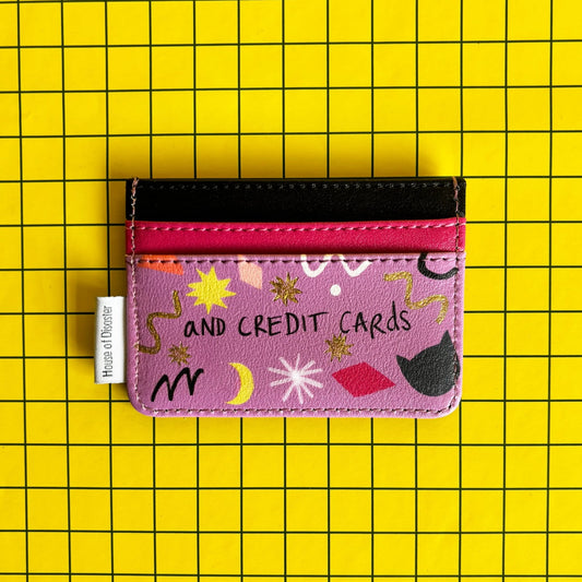 A colourful, compact PVC cardholder with abstract designs and the wording CREDIT CARDS, set against a yellow grid background—a fun and practical present for cat lovers.