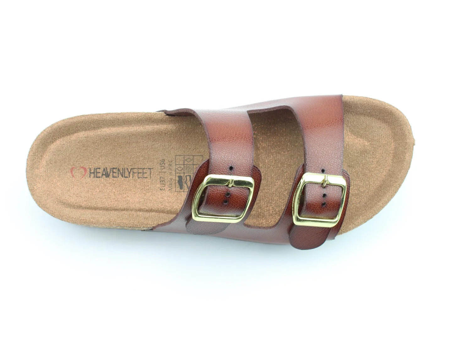 The Harmony2 Sandal is a brown slide with two adjustable straps and brass buckles on a cork footbed, branded HEAVENLYFEET on the insole. This premium sandal is also vegan-friendly, ensuring style and comfort for conscientious consumers.