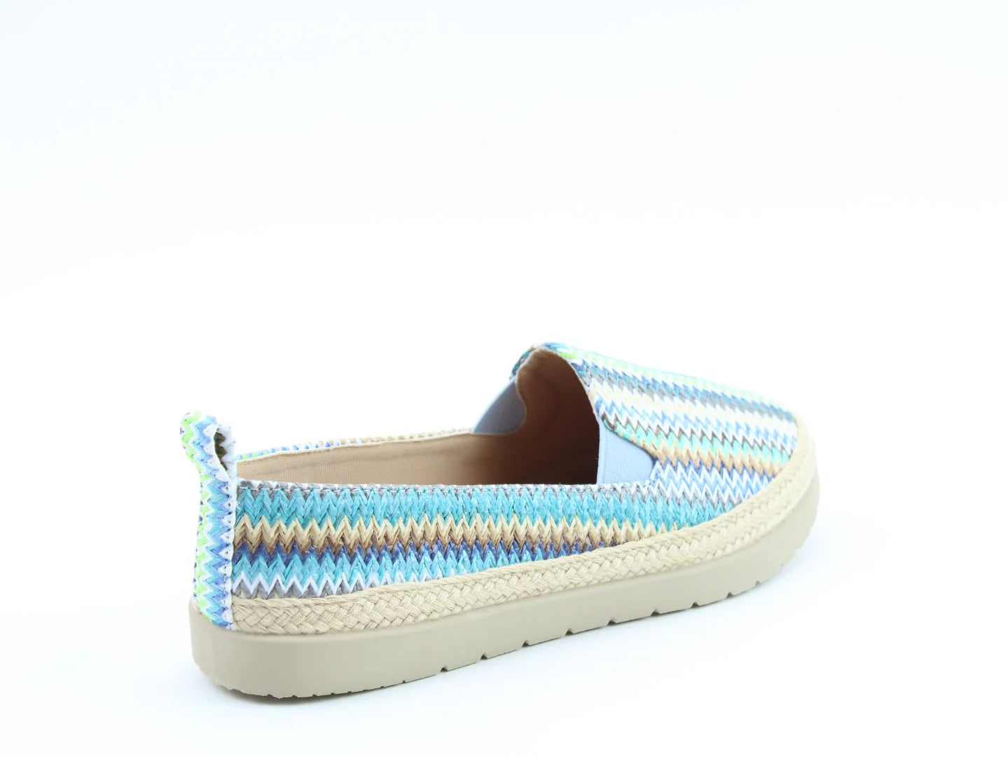 Side view of a colourful, vegan-friendly slip-on shoe with a zigzag pattern and woven sole, positioned against a plain white background.