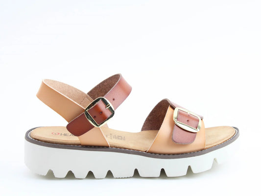 A brown and beige womens premium sandal with adjustable straps and metal buckles, featuring a thick white sole with a jagged pattern and a cushioned footbed, displayed against a white background.