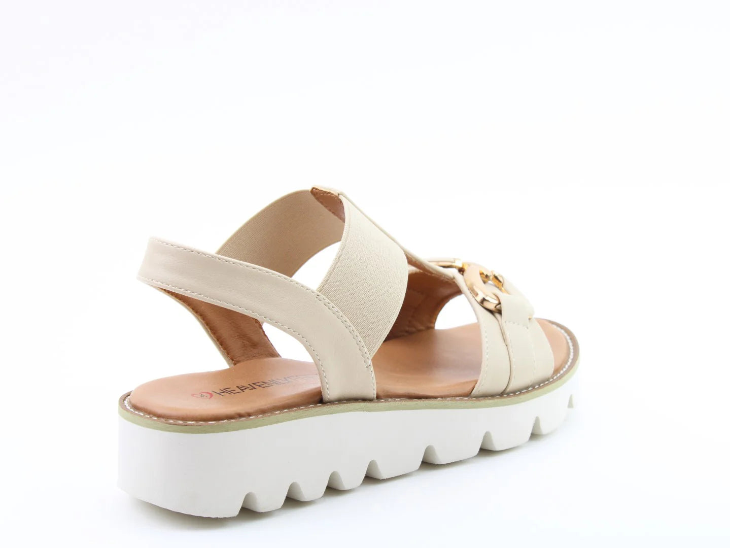 Beige Lulu2 Sandals feature a wide strap, a vegan-friendly white scalloped platform sole, and a decorative gold emblem at the front.