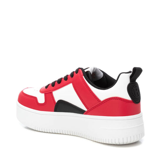 A red, white and black low-top women’s trainer with a thick white sole, black laces, and a black heel tab—crafted as a stylish, cruelty-free trainer, shown angled from the back.