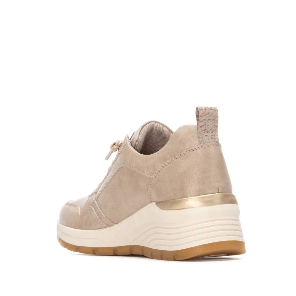 Beige and gold vegan trainers with a chunky white and tan sole, gold accent on the heel, suede-effect finish, and removable insoles. PETA-certified vegan. Shown from both the back and side.