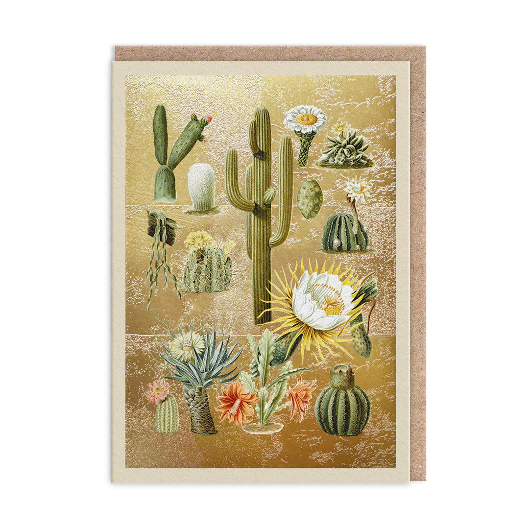A greetings card with a gold background featuring detailed illustrations of various cacti, succulents, and desert flowers.