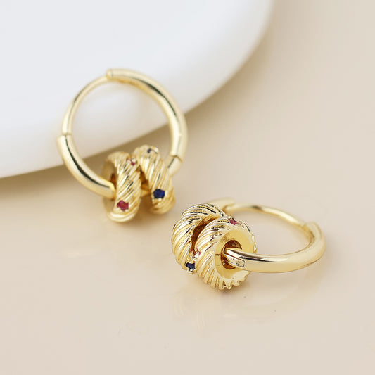 A pair of crystal hoop earrings featuring twisted knot detailing and small coloured gemstone accents, ideal for complementing any elegant jewellery set.