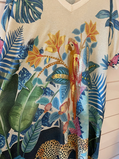A shirt showcasing a colourful pattern of tropical leaves, a parrot perched on a branch, and part of a leopard towards the hem—ideal for those who love striking animal print maxi dress styles.