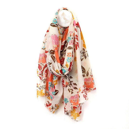 A lightweight floral scarf crafted from vegan materials, showcasing a colourful pattern in shades of pink, orange, blue, and brown on a white background, draped over a mannequin.
