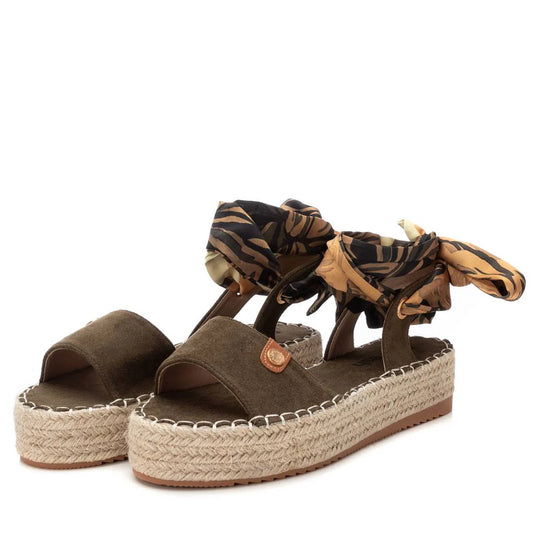 A pair of S.Ant Khaki vegan-friendly sandals with an olive green platform, jute soles, and tiger-print fabric ankle ties—an eye-catching touch of luxurious footwear.