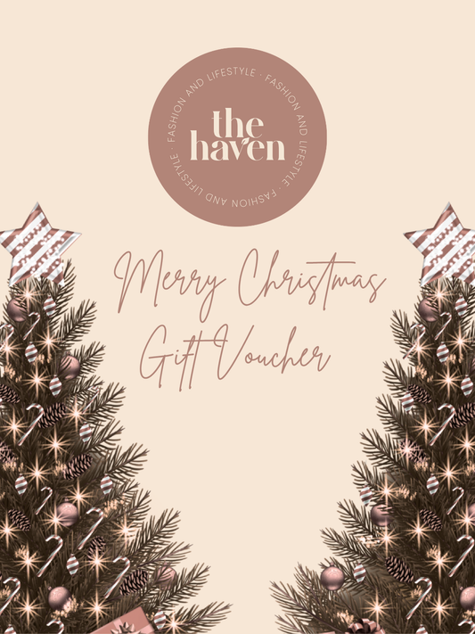 A Haven Fashion gift card featuring the text "Merry Christmas Gift Voucher", adorned with Christmas trees, stars, and festive decorations on a beige background.