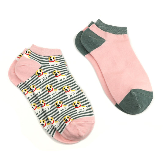 Two pairs of low-cut sustainable trainer socks: one in pink with a dark green heel and toe, the other striped with dog faces, pink detailing, and dark green stripes.