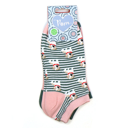 A pair of striped ankle socks with a pattern of dogs wearing Santa hats, featuring pink heels and toes, made from recycled materials and attached to Pom-branded packaging.