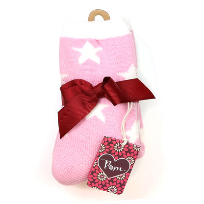 Cosy pink and grey socks with white star patterns, neatly folded and tied with a red ribbon, finished with a floral tag decorated with a heart and the letters PM.