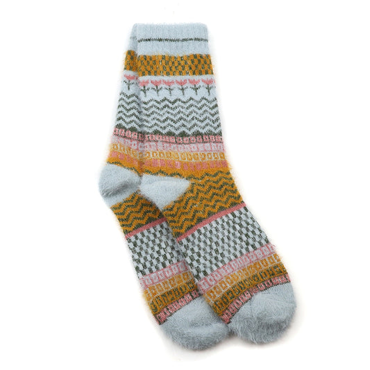 A pair of soft, sustainable socks with bands of blue, yellow, pink and grey zigzags and geometric designs, finished with a pale blue pattern, laid flat overlapping each other.