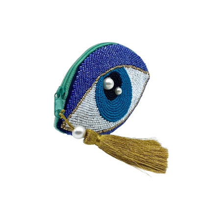 A small vegan-friendly coin purse featuring a beaded evil eye design, embellished with pearl beads and finished with a gold tassel on the zip—introducing your new Glimmer Eye Purse.