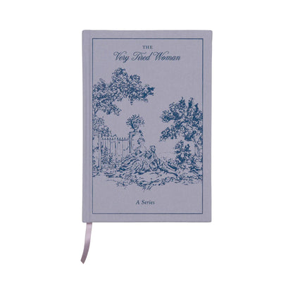A vintage journal with lay-flat binding, depicting women by a garden gate and the words “The Very Tired Woman: A Series” on the lavender-coloured cover.