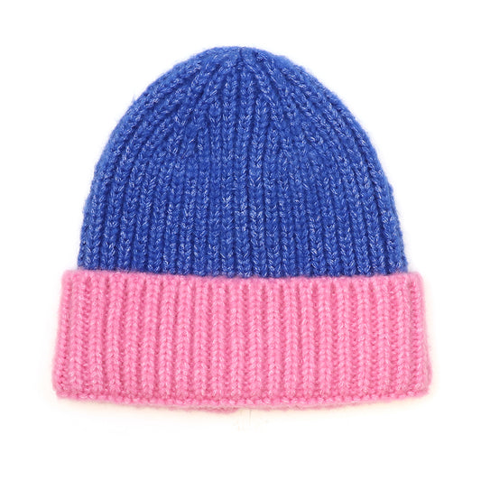 A vegan knitted beanie featuring a blue crown and a wide pink folded brim, made from sustainable materials—this winter essential is shown against a white background.