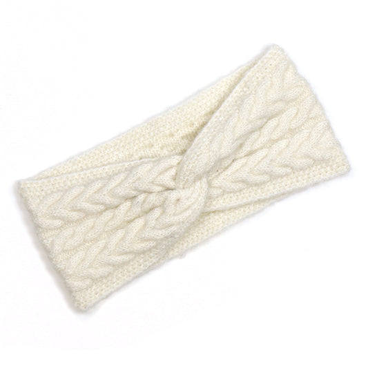 A cream knitted headband made from recycled vegan yarn, with a twisted centre and textured cable knit pattern for easy, sustainable style.