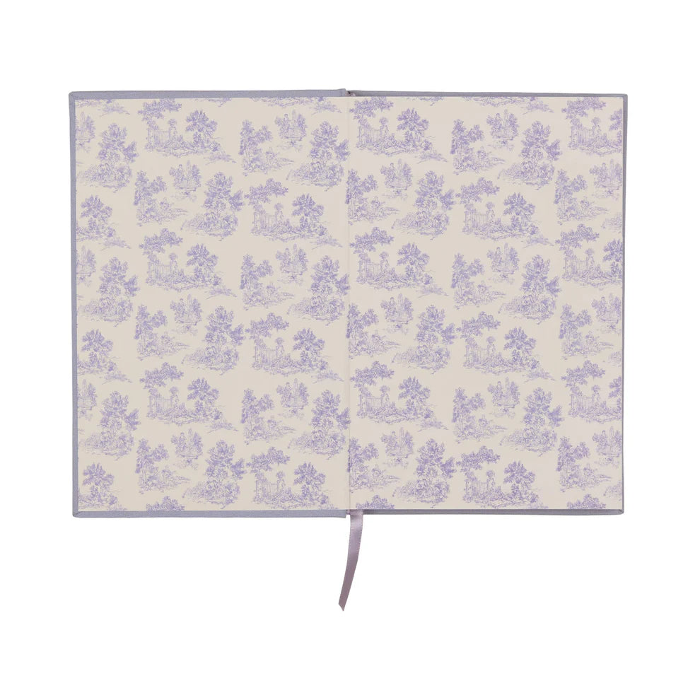 An open vintage journal with a light beige background and a repeating lavender floral pattern, featuring a lavender ribbon bookmark.