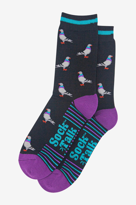 A pair of black men’s socks featuring pigeon patterns, purple heels and toes, teal and purple stripes on the soles, and “Sock Talk” text printed in teal. These bamboo socks are comfortable and stylish.