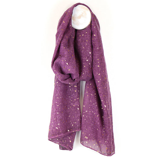 The Purple Gold Shimmer Summer Scarf, a vegan-friendly scarf adorned with tiny gold flecks, is draped over a white hook against a white background—ideal as an elegant summer accessory.