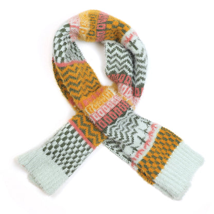 A vegan scarf featuring a multi-patterned design in yellow, green, white, orange, and pink is displayed in a loosely crossed arrangement on a white background.