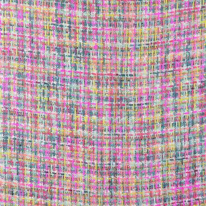 Close-up of a colourful multicoloured woven scarf showcasing a grid pattern with pink, yellow, blue, and white threads interlaced in a textured design—ideal for sustainable fashion enthusiasts.
