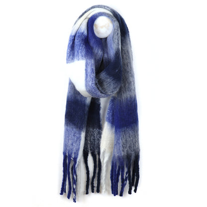 A long, fringed grey woven-texture scarf with a blue, white, and grey gradient pattern is hanging on a hook against a white background.