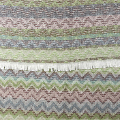 Fabric with a chevron striped pattern in muted green, brown, and blue tones, featuring a fringe along one edge—ideal for those who appreciate a unique multicoloured scarf.