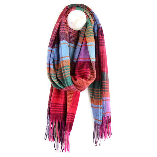 A berry check fringed scarf with multicoloured plaid and tasselled ends is draped in a loop and hung on a hook against a white background.