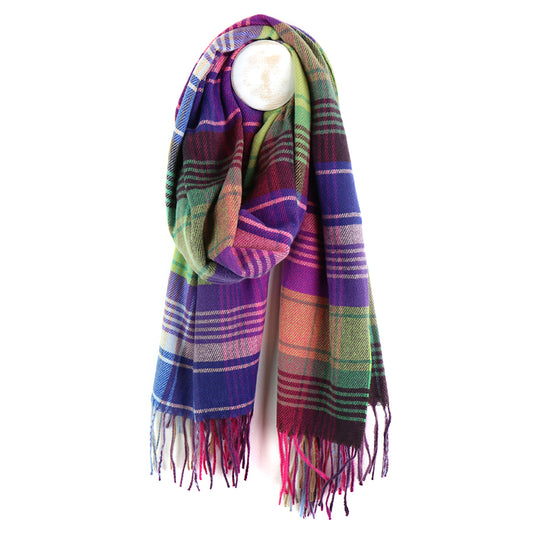 A multicoloured checked scarf with fringe hangs from a round white hook against a white background.