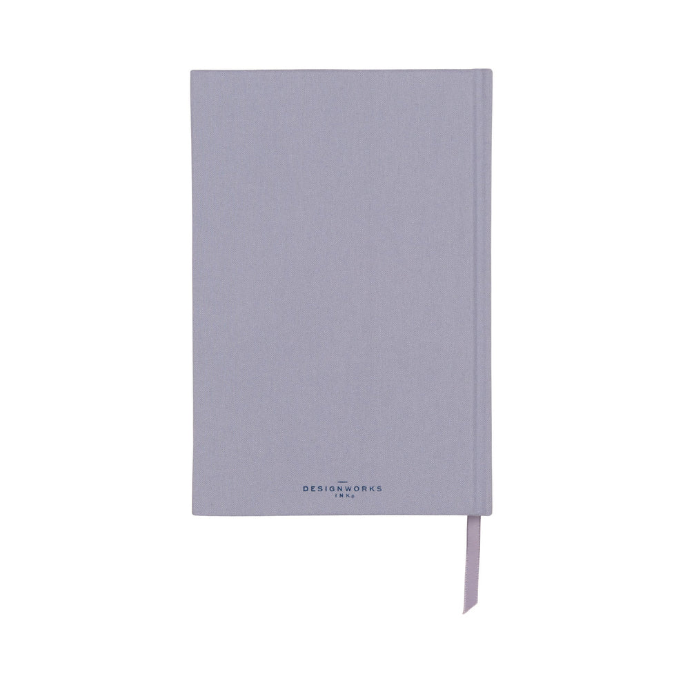 A closed, light purple bookcloth journal with a ribbon bookmark and 'DesignWorks Ink' printed on the front cover.