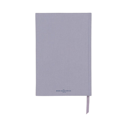 A closed, light purple bookcloth journal with a ribbon bookmark and 'DesignWorks Ink' printed on the front cover.