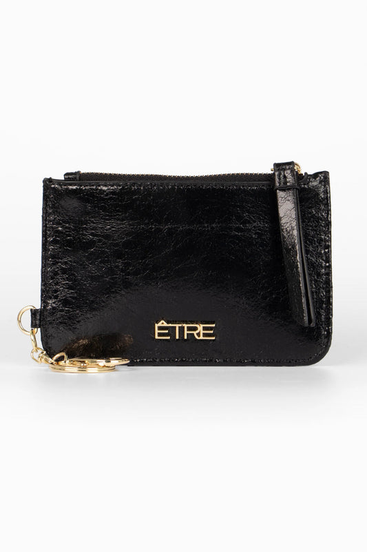 Black leather coin pouch featuring a cracked leather finish, gold zip, matching key ring, and the ÊTRE logo embossed in gold lettering on the front.