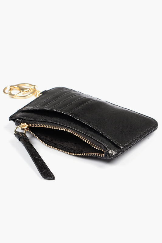 Metallic black card holder with a cracked leather finish, zipped pocket, keyring, multiple card slots, and gold zip, photographed on a white background.
