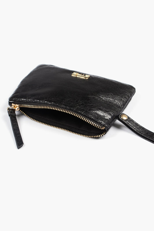 A small black wristlet purse made from metallic faux leather with a gold zip is partially open, showing the inside. The pouch has a wrist strap and gold lettering on the exterior.