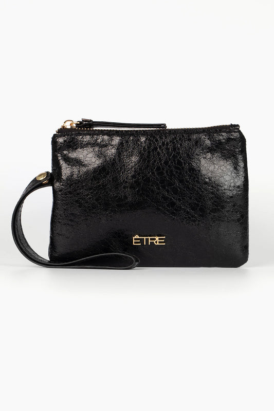 A small black vegan-friendly wristlet purse crafted from metallic faux leather, featuring a zip fastening, gold ÊTRE logo, and detachable wrist strap, shown against a plain white background.