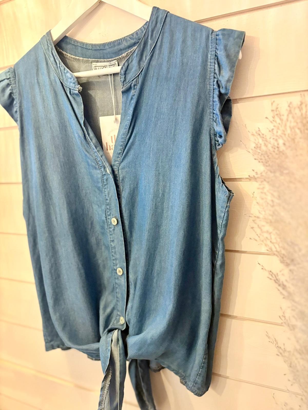 A blue, eco-friendly shirt crafted from vegan materials displayed on a mannequin.