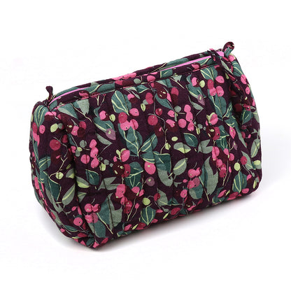 A quilted make-up bag with a zip, showcasing a deep purple background adorned with a green and pink floral design—ideal for keeping your beauty essentials. Presenting the delightful Winter Berry Quilted Make-up Bag.