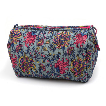 Rectangular quilted make-up bag with a blue background and a colourful floral pattern in pink, yellow, and navy, featuring a zip fastening on the top.