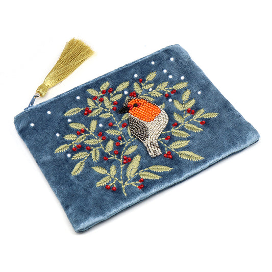 Blue velvet zipped purse with a gold tassel, featuring a beaded bird perched on a branch decorated with leaves and red berries.
