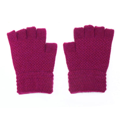 A pair of magenta fingerless gloves with a cosy waffle texture, shown against a white background.