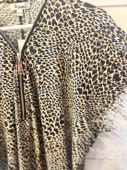 Close-up of a garment with a leopard print pattern, featuring a copper zip and a tag that reads Misun i.