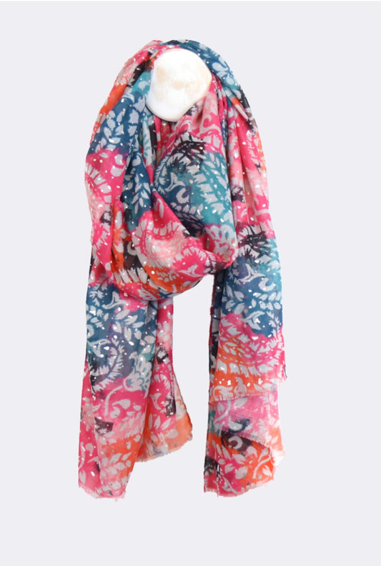 A lightweight accessory, this multicoloured vegan fabric scarf boasts a floral pattern in shades of pink, blue, orange, and white, stylishly draped on a white mannequin bust.