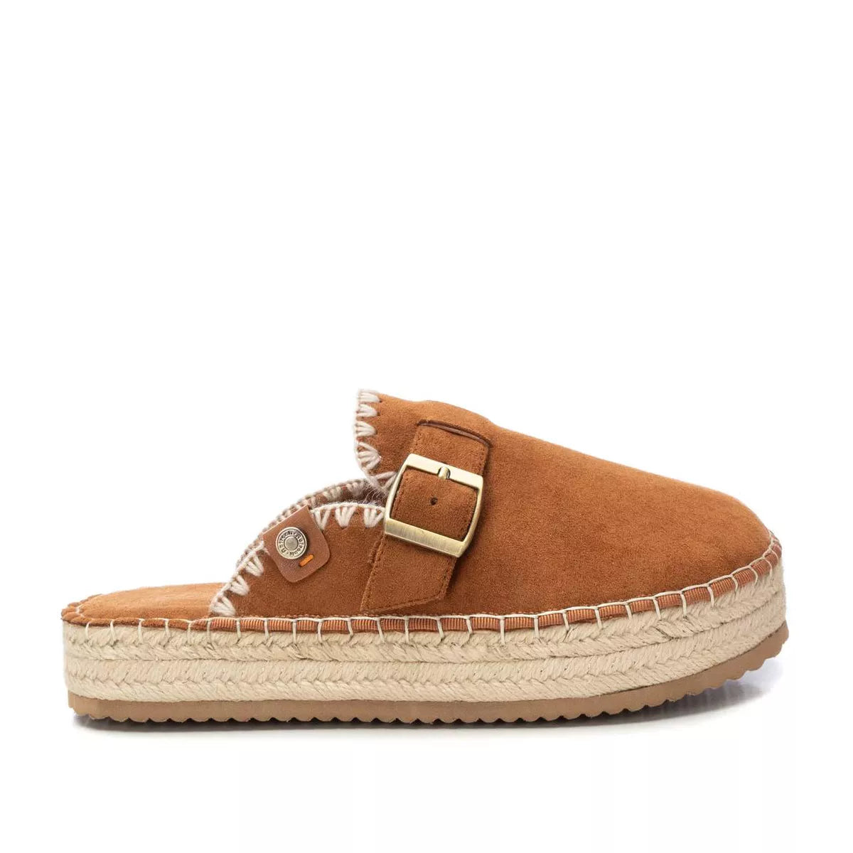 A women’s espadrille in brown suede with a platform sole, large gold buckle, and prominent white stitching—these vegan-friendly tan sandals blend style and comfort effortlessly.