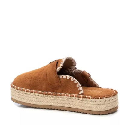 A brown suede slip-on espadrille mule featuring exposed white stitching and a thick woven jute platform sole, these vegan-friendly women’s espadrilles offer effortless style and comfort.