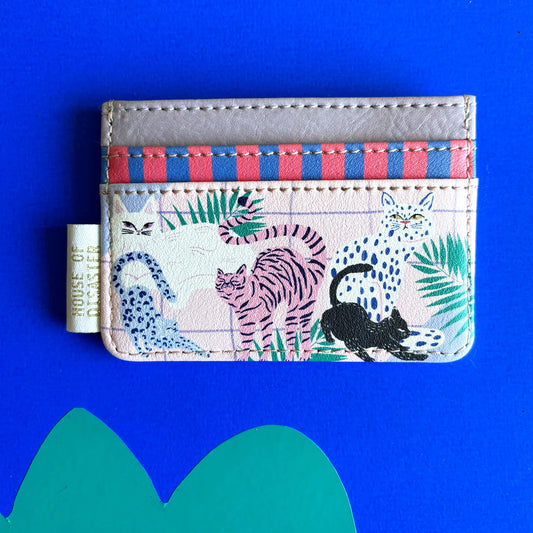 A beige cat cardholder adorned with playful cat illustrations and colourful plants, featuring a striped top section, displayed against a blue background.